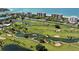 Breathtaking aerial view of a meticulously maintained golf course with water hazards and beachfront condos at 3491 Bayou Sound, Longboat Key, FL 34228