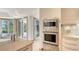 Kitchen showcasing stainless steel appliances and sleek cabinetry, leading to outdoor access at 3491 Bayou Sound, Longboat Key, FL 34228