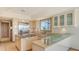Modern kitchen with stone countertops, island, stainless steel appliances, breakfast bar and sleek cabinetry at 3491 Bayou Sound, Longboat Key, FL 34228