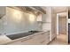 Well-appointed kitchen features modern range with hood and sleek cabinets at 3491 Bayou Sound, Longboat Key, FL 34228