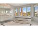 Elegant bathroom with a standalone tub, plenty of windows, and patterned floor trim at 3491 Bayou Sound, Longboat Key, FL 34228