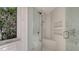 A tiled walk-in shower featuring a rain shower head, a bench, and built in shelving at 3491 Bayou Sound, Longboat Key, FL 34228