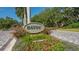 Welcome to Bayou! Beautiful neighborhood entrance with lush landscaping and welcoming signage at 3491 Bayou Sound, Longboat Key, FL 34228