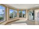 Bright sunroom with expansive windows offering stunning views of the surrounding landscape and waterway at 3491 Bayou Sound, Longboat Key, FL 34228