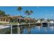 Luxurious waterfront property with a private dock and multiple boats, reflecting on calm waters at 3491 Bayou Sound, Longboat Key, FL 34228