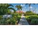 Inviting entrance to Longboat Key Yacht Club with lush landscaping and clear blue skies at 3491 Bayou Sound, Longboat Key, FL 34228