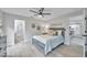 Comfortable bedroom with neutral paint, wood-look floors, ceiling fan, and natural light at 3502 Wilkinson Woods Dr # 7, Sarasota, FL 34231