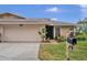 Inviting exterior showcasing a well-maintained home with a landscaped yard and attached garage at 3502 Wilkinson Woods Dr # 7, Sarasota, FL 34231