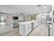 Open concept living room featuring hardwood floors, modern furnishings, kitchen, and stainless steel appliances at 3502 Wilkinson Woods Dr # 7, Sarasota, FL 34231
