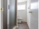 A view into the bathroom featuring a stand-up shower with glass doors and modern fixtures, as well as wood-look floors at 353 Hillview Rd, Venice, FL 34293