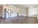 Open-concept living area featuring modern kitchen appliances, white cabinetry, and wood-look flooring at 353 Hillview Rd, Venice, FL 34293
