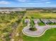 An aerial image showcases a home in a suburban neighborhood, highlighting nearby greenery and landscaping at 3631 Pebble Ter, Punta Gorda, FL 33980