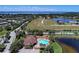 Aerial view of the community featuring a pool, lakes, green spaces, and residential areas at 3631 Pebble Ter, Punta Gorda, FL 33980