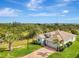Aerial view of a well-maintained one-story home, complemented by a brick driveway and mature landscaping at 3631 Pebble Ter, Punta Gorda, FL 33980