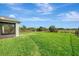 Spacious backyard features lush green grass and a partial fence line with views of a nature preserve at 3631 Pebble Ter, Punta Gorda, FL 33980