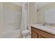This bathroom has a tub with shower, white cabinet and granite countertop at 3631 Pebble Ter, Punta Gorda, FL 33980