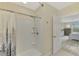 This bathroom features a shower with tile surround and an open door to a bedroom at 3631 Pebble Ter, Punta Gorda, FL 33980