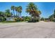 The River entrance sign sits among palm trees and lush green landscaping on a sunny day at 3631 Pebble Ter, Punta Gorda, FL 33980