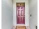 Elegant front entry with a six-panel maroon door and 'Welcome' doormat at 3631 Pebble Ter, Punta Gorda, FL 33980