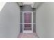 A screened entryway showcases a classic front door, with muted colors at 3631 Pebble Ter, Punta Gorda, FL 33980
