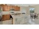 Open kitchen with stainless steel appliances, granite counters, and adjacent breakfast nook at 3631 Pebble Ter, Punta Gorda, FL 33980