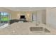 Bright kitchen island sink with stainless steel faucet adjacent to the living room at 3631 Pebble Ter, Punta Gorda, FL 33980