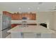 Bright kitchen with stainless steel appliances and large island with breakfast bar at 3631 Pebble Ter, Punta Gorda, FL 33980