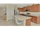 Modern kitchen with stainless steel appliances and a large granite island with seating at 3631 Pebble Ter, Punta Gorda, FL 33980