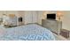 This main bedroom has hard surface floors and dresser with tv at 3631 Pebble Ter, Punta Gorda, FL 33980