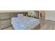 This primary bedroom features hard surface floors, a patterned bedspread and ensuite bathroom at 3631 Pebble Ter, Punta Gorda, FL 33980