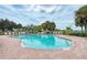 Resort-style pool area surrounded by palm trees and plenty of lounge chairs at 3631 Pebble Ter, Punta Gorda, FL 33980