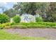The community sign for River Club sits among carefully placed green landscaping at 3631 Pebble Ter, Punta Gorda, FL 33980