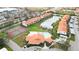 Community aerial view showcasing pool, tennis courts, clubhouse, and serene pond views at 4240 Marseilles Ave # 3248, Sarasota, FL 34233
