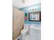 Cozy bathroom with a shower and tub, featuring an artful mirror and vibrant wall art at 4240 Marseilles Ave # 3248, Sarasota, FL 34233