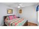 Colorful bedroom with a ceiling fan, wooden floors and lots of natural light at 4240 Marseilles Ave # 3248, Sarasota, FL 34233