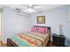 Comfortable bedroom with a ceiling fan, wooden floors and lots of natural light at 4240 Marseilles Ave # 3248, Sarasota, FL 34233