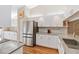 Modern kitchen showcasing stainless steel refrigerator and sleek white cabinets at 4240 Marseilles Ave # 3248, Sarasota, FL 34233