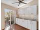 Bright kitchen featuring access to the backyard, white cabinets, and a ceiling fan at 4240 Marseilles Ave # 3248, Sarasota, FL 34233