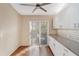 Well-lit kitchen featuring hardwood floors, white cabinets, and access to the backyard at 4240 Marseilles Ave # 3248, Sarasota, FL 34233