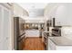 Well-lit kitchen boasts stainless steel appliances, vaulted ceiling, and open layout at 4240 Marseilles Ave # 3248, Sarasota, FL 34233