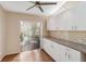 Bright kitchen featuring white cabinets, hardwood floors, and a sliding glass door at 4240 Marseilles Ave # 3248, Sarasota, FL 34233