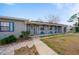 Exterior view of a quaint single-story home with a covered porch at 450 Dalton Blvd, Port Charlotte, FL 33952