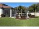 Lush landscaping surrounds the screened lanai and pool in this meticulously maintained backyard at 4725 Arbor Gate Dr, Bradenton, FL 34203