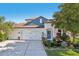 Beautiful two-story home with a three car garage and a well manicured front yard at 4725 Arbor Gate Dr, Bradenton, FL 34203