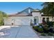 Charming home featuring a three-car garage and inviting front yard landscaping at 4725 Arbor Gate Dr, Bradenton, FL 34203