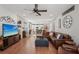 Spacious living room with an open floor plan, hardwood floors, and a view into the kitchen and dining areas at 4725 Arbor Gate Dr, Bradenton, FL 34203
