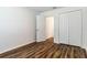 Bedroom features a closet, wood-look flooring, and a doorway leading to another room at 4757 Vaquero St, North Port, FL 34286