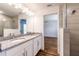 Bright bathroom featuring double vanity with granite countertop and a glass-enclosed shower at 4789 Vaquero St, North Port, FL 34286
