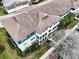 Aerial view of a condo building showcasing its well-maintained roof and surrounding landscaping at 4802 51 W St # 1017, Bradenton, FL 34210