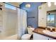 Bathroom featuring a tub/shower, a sink with granite countertops, and blue accent walls at 4802 51 W St # 1017, Bradenton, FL 34210